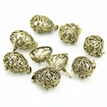 Close-up of vintage hollow locket pendants with intricate patterns for DIY jewelry making - Silver Hollow Ball Pendant (YJ6-1060)