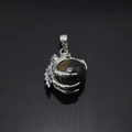 Detailed view of silver dragon claw pendant with rotating tiger eye stone sphere - Tiger Eye Style (Style 5)