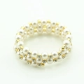 Three-layer wrap bracelet featuring white pearls, gold spacers, and sparkling rhinestones - Gold