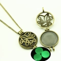 Macro detail of bronze hollow tree pendant glowing green in dark background - Vines Hollow Style (YJ10-6103) / Green