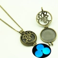 Retro bronze hollow circular pendant necklace showing blue luminous glow in the dark - Leaves Hollow Style (YJ10-6105) / Blue