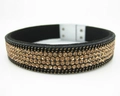 Macro view of black suede bracelet featuring triple rows of champagne gold rhinestones - Gold Champagne