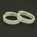 Detailed macro view of two-piece triple-layer pearl and rhinestone elastic bracelets - Silver Style Two