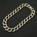 Detailed view of gold Cuban link necklace with sparkling crystals on a black display mat - Gold - Necklace