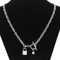Titanium steel OT buckle necklace with lock and bell pendants on a black neck bust - Silver