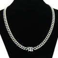 Macro detail of silver Cuban link chain featuring a polished Gothic letter M pendant - Necklace / Silver - Letter M Pendant