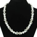 Punk style pearl and silver metal thorn choker necklace displayed on a black velvet bust - Pearl White
