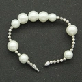 Detail of alternating white pearls and silver metal cylinders on a beaded bracelet - Five Pearls Style - Bracelet