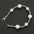 Detailed macro view of large white pearls and polished silver beads on the lobster clasp bracelet - Pearl + Bead Chain - Bracelet