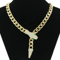 Macro shot of gold Cuban link snake necklace with shimmering rhinestones and green eyes - Green Eyes Necklace / Gold