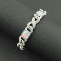 Macro shot of silver hip-hop Cuban bracelet featuring iced-out rhinestones and colorful crystals - Silver