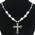 Gothic cross necklace featuring white pearls and rhinestone pendant on black background - Cross Style