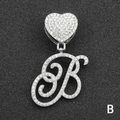 Macro detail of silver tone iced out letter B pendant with heart clasp and clear crystals - Letter B / Silver