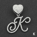 Detail of iced out letter K pendant with heart clasp and crystal paving on black background - Letter K / Silver