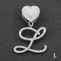 Macro shot of a silver iced-out cursive letter L pendant with a heart-shaped clasp - Letter L / Silver