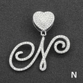Macro shot of silver letter N pendant with iced out rhinestones and heart clasp - Letter N / Silver