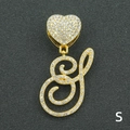 Detail of gold iced out S letter pendant with heart clasp and sparkling crystal rhinestones - Letter S / Gold