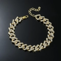 Iced out Cuban link anklet with rhinestones in gold finish on black background - Gold