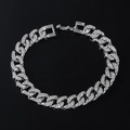 Close-up of silver Cuban link chain with paved rhinestones and secure clasp detail - Bracelet / Silver