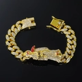 Detailed macro view of gold-plated hip-hop Cuban link bracelet with red and white rhinestones - Gold