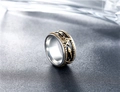 Macro detail of vintage bicolor Freemason spinner ring with engraved Masonic symbols - US 7 / Gold & Silver