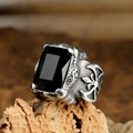 Macro shot of gothic stainless steel ring with rectangle black gem and cross relief - US 7 / Steel Color Black Gemstone