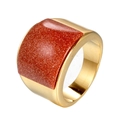 Macro detail of wide gold band ring featuring a sparkling brown goldstone inlay - Orange Rhinestones