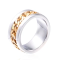 Macro view of industrial punk ring with golden chain inlay on polished silver steel band - Gold
