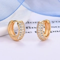 Macro detail of gold hoop earrings with three rows of sparkling pave-set white zircon stones - Gold
