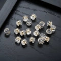 Close-up of clear silicone 18K gold plated earring backs on a dark wood tray - Earring Back Only (Single) / Gold
