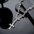 Dettaglio macro della collana a croce argento vintage con strass e maglie floreali - Collana a Croce