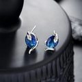 Gothic silver snake earrings with oval dark blue gemstone inlay on a matte black stand - Silver Color Blue Zircon Snake