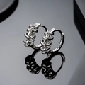 Macro detail of silver geometric stacked snake-style hoop earrings with mirror finish - Snake Plain Hoop Style (E1220-C)