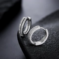 Detailed close-up of sterling silver hoop earrings with double-row zircon pavé on dark rock - Double Row Rhinestone Earrings (X1010-A)