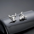 Macro detail of silver ox head earrings with vintage textured finish and detailed horn carving - Silver Bull Head Stud Earrings / Silver