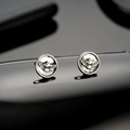 Polished silver eagle stud earrings featuring detailed eagle relief on black mirror background - Silver