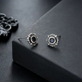 Detail view of retro octagon star earrings with dark gemstone and S925 silver finish - Blue