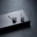 Polished silver skull stud earrings in punk gothic style with detailed metallic engraving - Skull Stud Earring (X752-A)