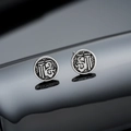Macro shot of vintage matte silver round studs with intricate character engravings - Double Fu Stud Earrings (Silver) / 8mm
