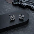 Close-up of vintage gothic cross earrings with white zircon on a black stone background - Gun Black Pair (X765-C)