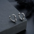 Detailed view of vintage heart earrings with intricate baroque engravings on a stone block - Heart Relief Ear Buckle (Single Piece) (X536-A)
