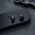 Macro view of gothic black stud earrings with dark blue gemstone and claw setting - Gun Black Blue Zirconia Style (X561-I)