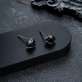 Close-up of black metal eye-shaped stud earrings featuring a faceted black gemstone center - Gun Black Black Zirconia Style (X561-H)