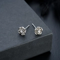 Close-up of silver rose stud earrings featuring a central sparkling zircon inlay - Rose Style (X564-A)