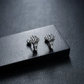 Macro shot of silver gothic skull hand earrings with detailed bone joints and ball back closure - Silver (Single Piece)