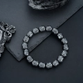 Men's gunmetal Buddha head hematite beaded bracelet on a dark textured stone background - Buddha Head Style (S518-A)