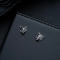 Macro detail of zodiac tiger stud earrings with antique silver finish and carved texture - Gun Black Ear Clip (X1023-D)