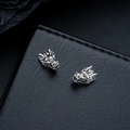 Macro view of vintage silver dragon head earrings on black leather texture background - Clip-on Earrings / Silver