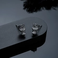 Macro detail of dark gunmetal dragon head earrings with intricate scale texture - Stud Earrings / Gunmetal