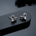 Macro shot of antique silver ram head stud earrings with detailed horns and texture - Goat (Silver)